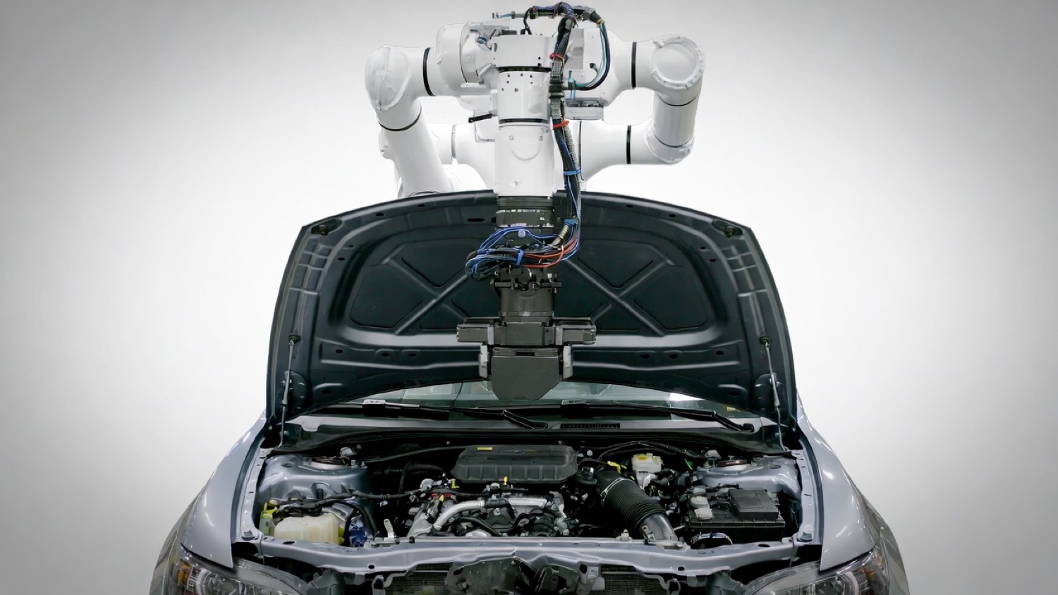 Robot working on car engine